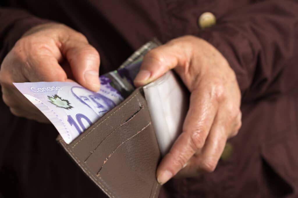 Person getting a bill from a wallet